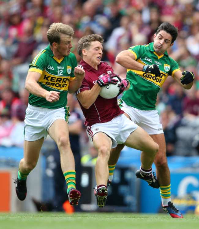 Donal O&rsquo;Neill is tackled by Aidan O&rsquo;Mahony and Donnchadh Walsh
