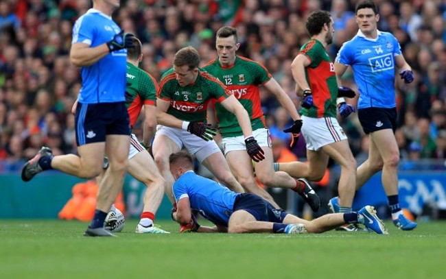 Jonny Cooper holds back Donal Vaughan