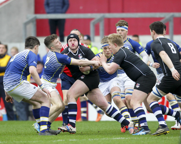 Conor Clancy is tackled by Bryan Fitzgerald
