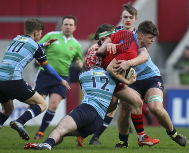 Jake Murphy is tackled by Graham Bourke and Aaron Kennedy