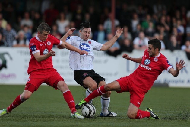 Richie Towell tackled by Jeff Henderson and Seamus Conneely