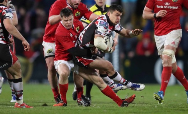 Munster’s Johnny Holland tackles Edinburgh’s Damien Hoyland