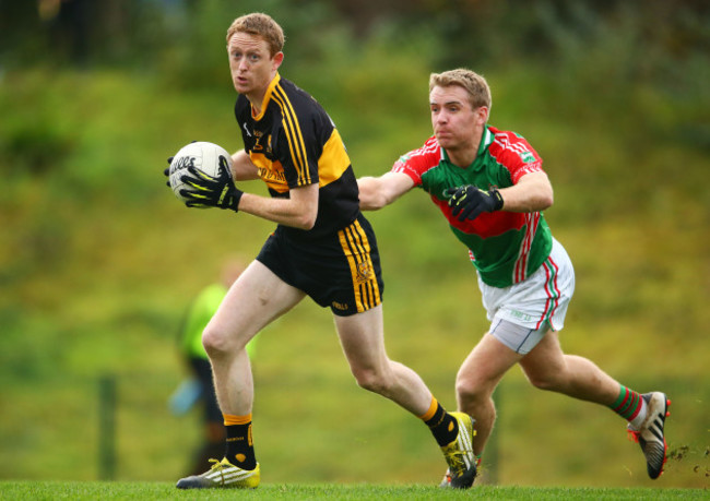 Colm Cooper is tackled by Noel McGrath