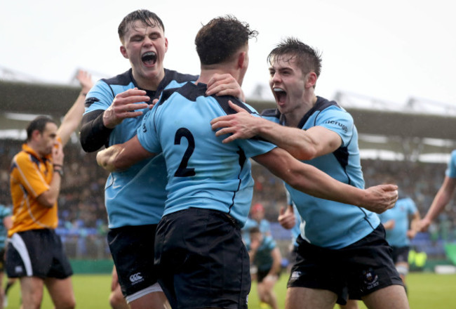 Stephen Judge celebrates with David Ryan and Christopher Carey after scoring their second try