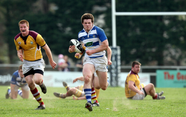 Conor Gaston runs in a try