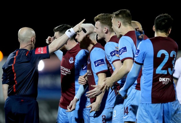 Drogheda players surround referee Rob Rogers after sending Jason Marks off