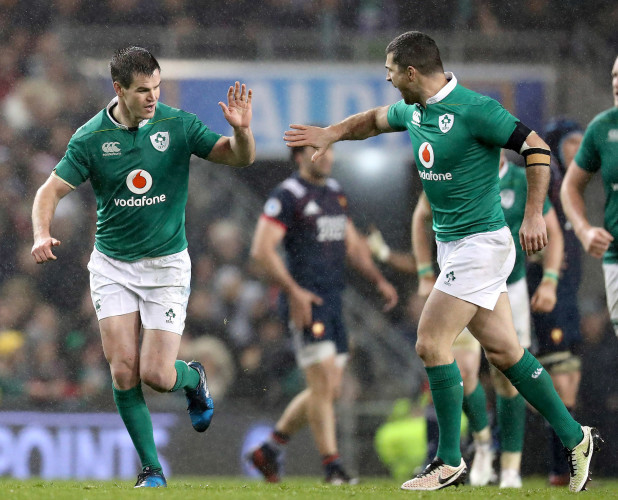 Jonathan Sexton celebrates kicking a drop goal and is congratulated by Rob Kearney
