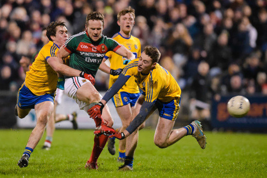 Andy Moran shoots at goal despite the tackle of Niall McInerney