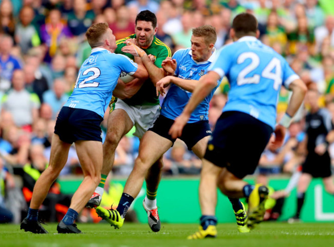 Ciaran Kilkenny and Paul Mannion tackle Bryan Sheehan