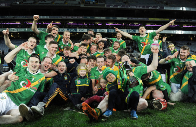 Carrickshock players and supporters celebrate with the cup