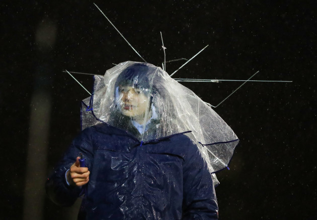 A Connacht fan shelters from the rain