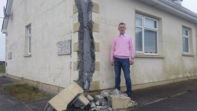 Mick Healy standing by wall