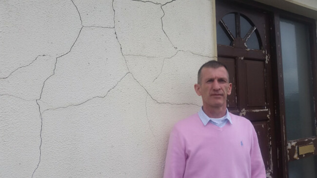 Mick standing by front door