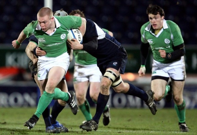 Keith Earls supported by Shane Monahan gets tackled by the Scottish defence