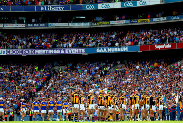 The Tipperary and Kilkenny team stand fro the National Anthem