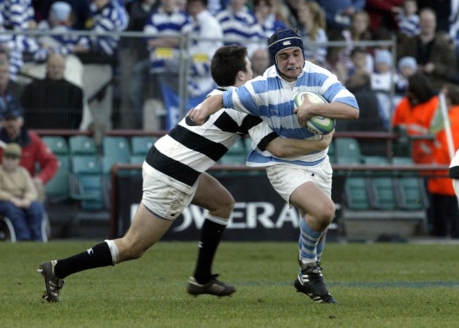 Eoin Fleck of Blackrock tackled by Eoin O'Malley of Belvedere