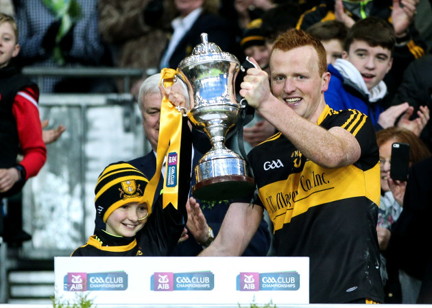 Dr. Crokes' Johnny Buckley lifts the cup with Amy O'Connor