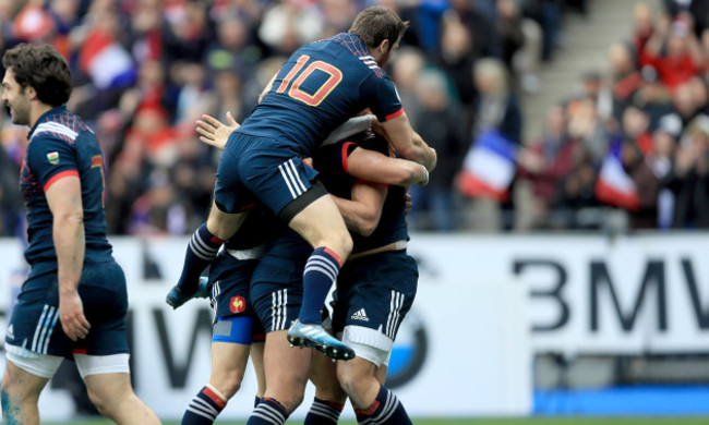 Remi Lamerat celebrates scoring a try with teammates