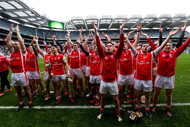 Cuala celebrate with the trophy to the fans
