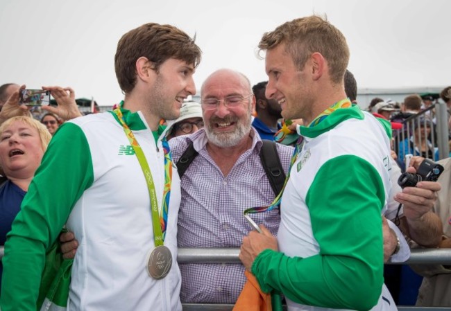 Paul and Gary O'Donovan celebrate winning a silver medal with father Teddy