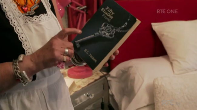 host with 50 shades of grey and the bible beside her bed
