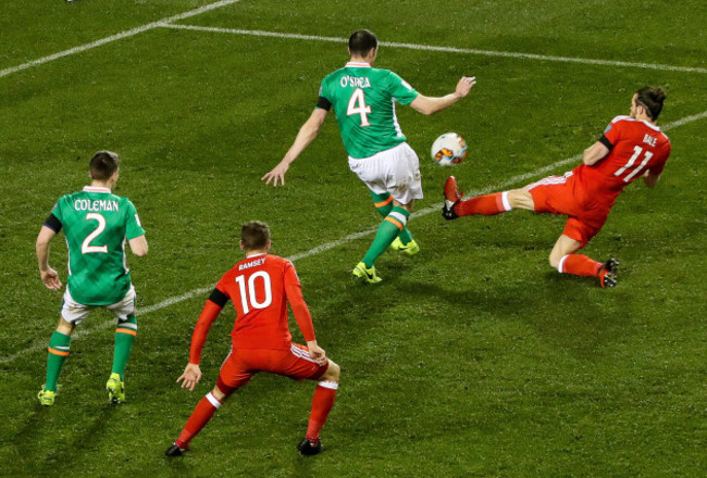 Gareth Bale is yellow carded for a high challenge on John O'Shea