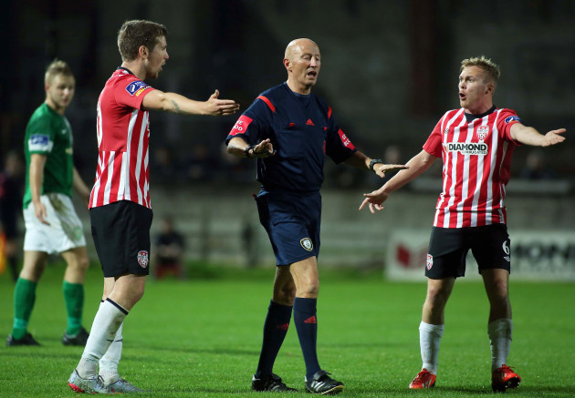 Patrick McEleney and Conor McCormack protest with referee Paul Tuite
