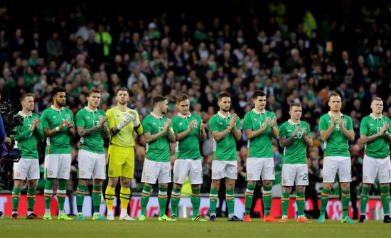 The Ireland team observe a minutes applause