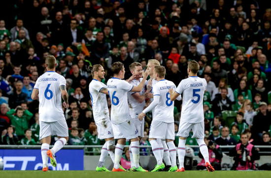 Hordur Bjorgvin Magnusson celebrates scoring the first goal of the game with teammates