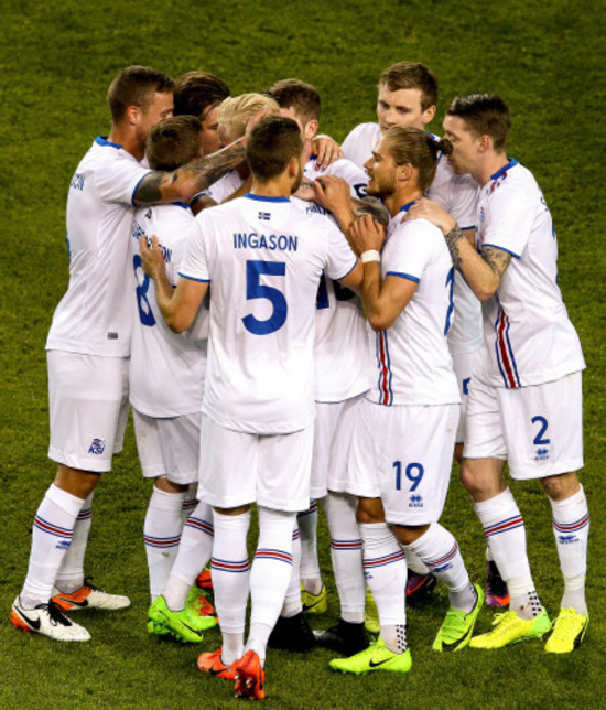 Hordur Bjorgvin Magnusson celebrates scoring a free kick with teammates