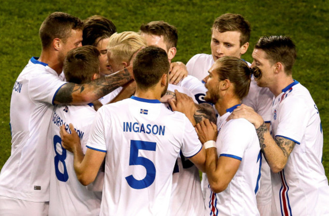 Hordur Bjorgvin Magnusson celebrates scoring a free kick with teammates