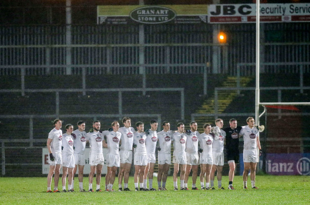 The Kildare team stand for the national anthem
