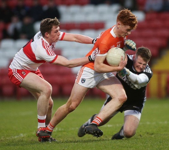 Armagh's Jason Duffy with Michael McEvoy and Ben McKinless of Derry