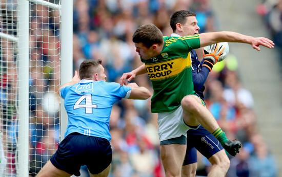 Darren Daly and goalkeeper Stephen Cluxton tackled by Kevin McCarthy