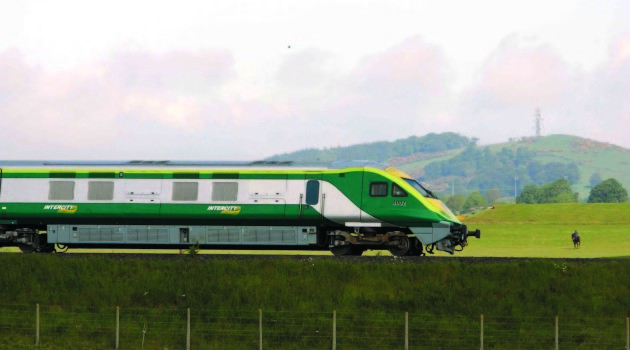 2/6/2006 The new Irish Rail Mark 4 Train flys through the County Kildare countryside on its way to Cork City, with a horse and rider and Dunmurray hill in the background. Photo: Eamonn Farrell/Photocall Ireland.