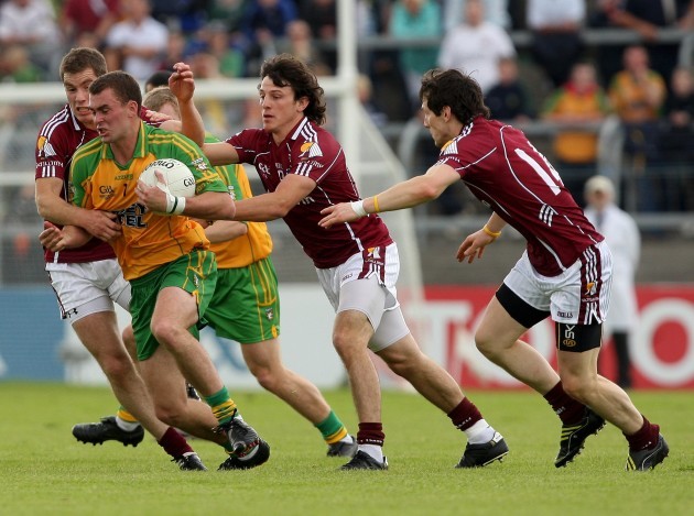 Eamon McGee tackled by Niall Coleman, Sean Armstrong and Michael Meehan