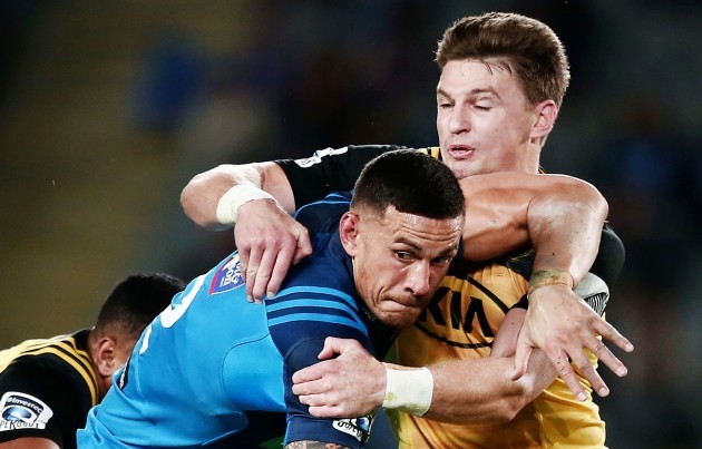 Sonny Bill Williams is tackled by Beauden Barrett and Ngani Laumape