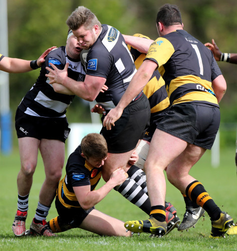 James McWilliams Gray is tackled by Jack Lyons and Gavin Ryan