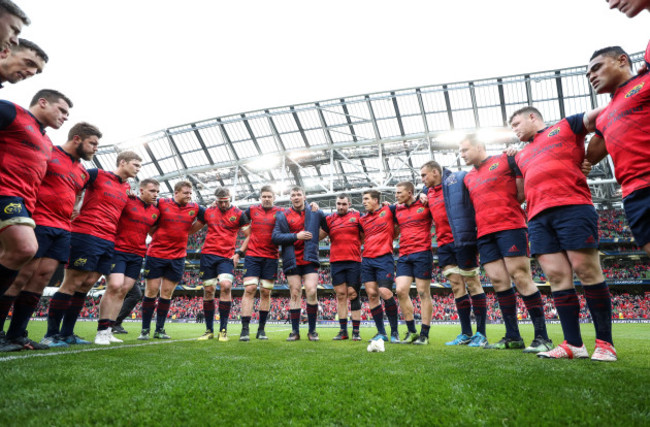 Munster players huddle after the game