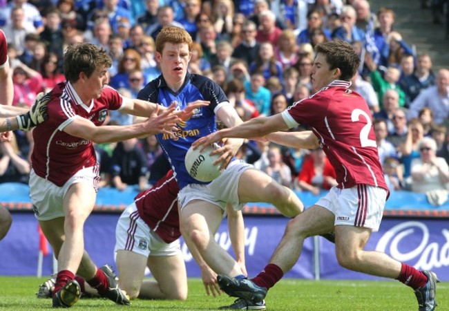 Niall McDermott tackled by Joss Moore and Gary Sweeney