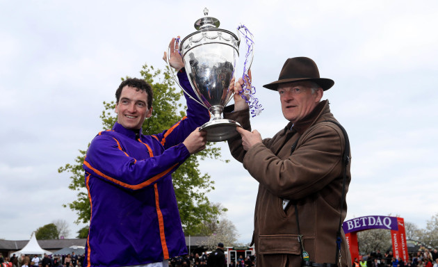Patrick Mullins and trainer Willie Mullins celebrate with the trophy after winning