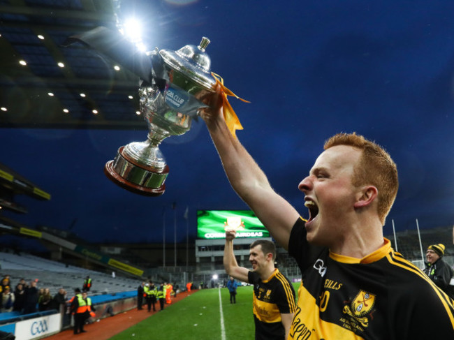 Johnny Buckley celebrates with the trophy after the game