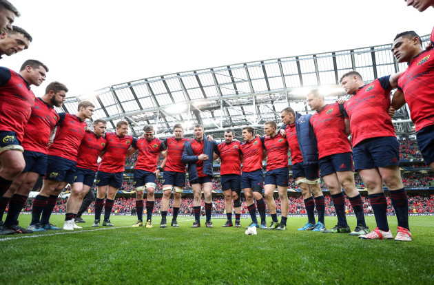 Munster players huddle after the game