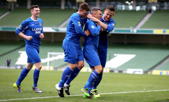 Stephen Murphy celebrates scoring with Joe O'Neill and Gavin McDermott