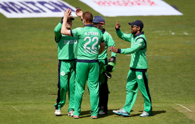 Kevin O'Brien celebrates taking a wicket with his teammates