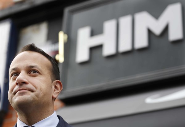 Pictured is Minister Leo Varadkar standing under a sign that says HIM