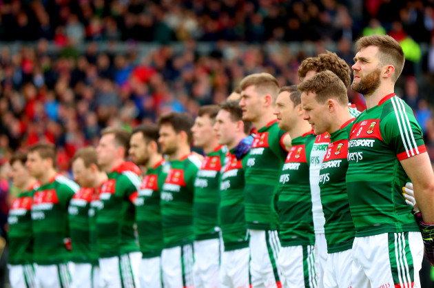 Seamus O'Shea stands with his team for the anthems