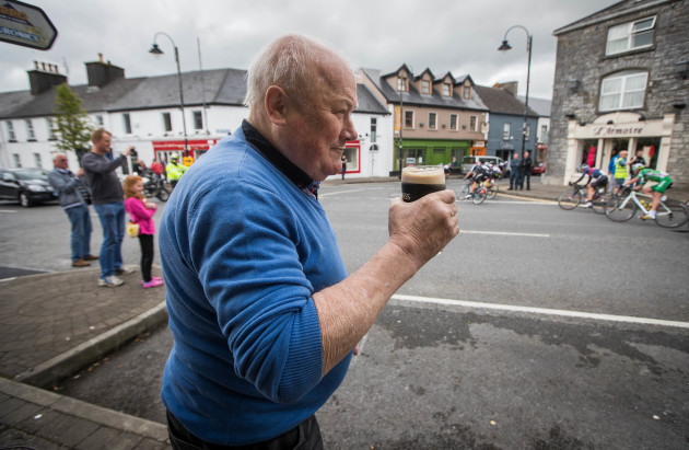Peter Gill from Claremorris watches The Ras pass through the town