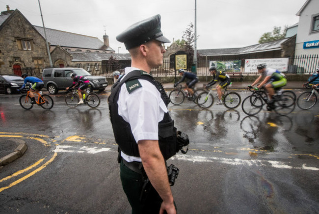 A PSNI Officer looks on as the Ras as it makes its way through Lisnaskea