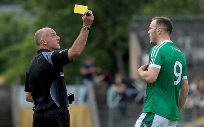 Cormac Reilly issues a yellow card to David Ward